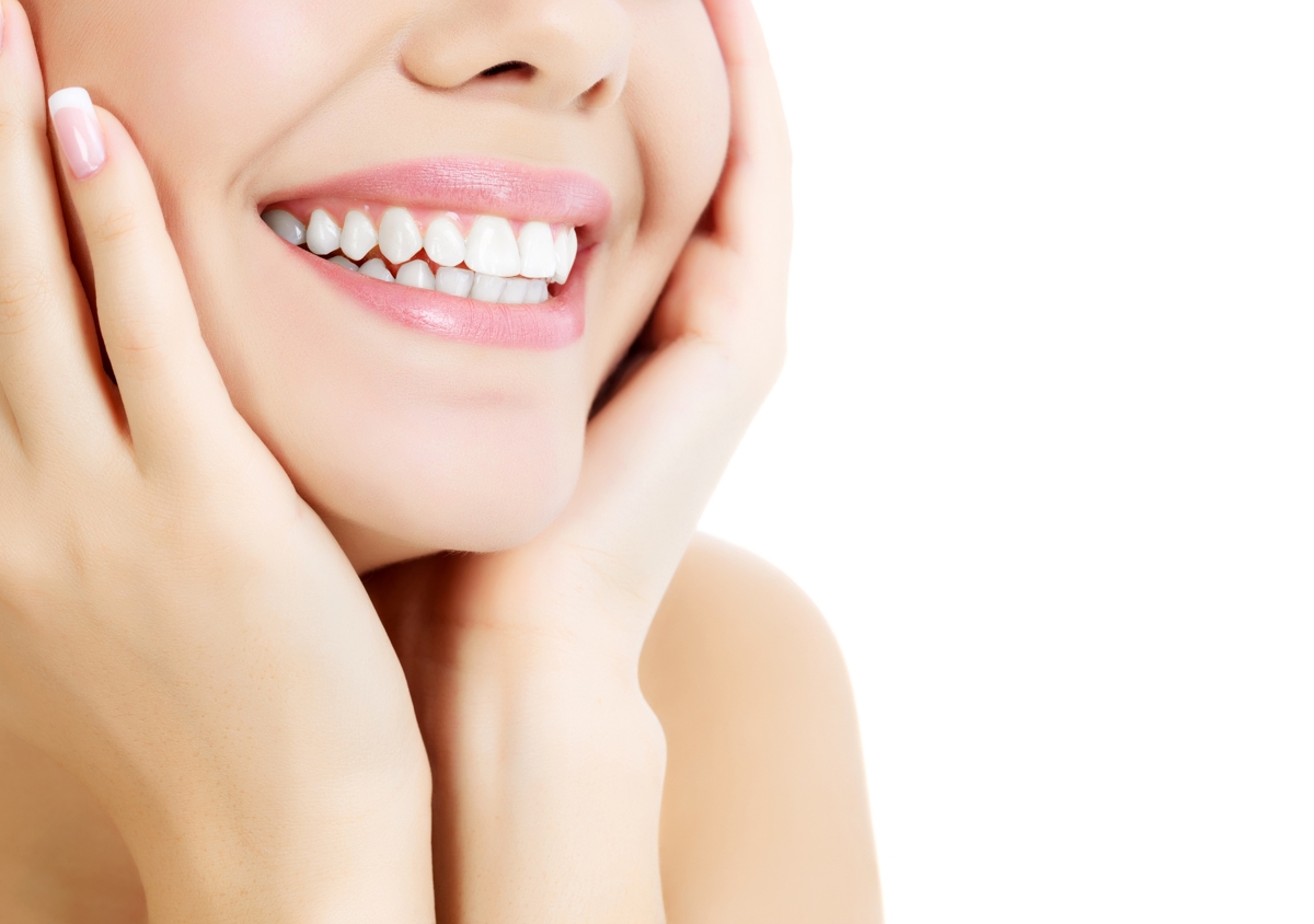 Cheerful female with fresh clear skin, white background